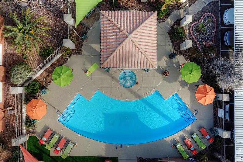 Aerial View of Pool | Stretch out on our vibrant pool loungers or have a picnic under the shade of our umbrellas from the Arizona rays!