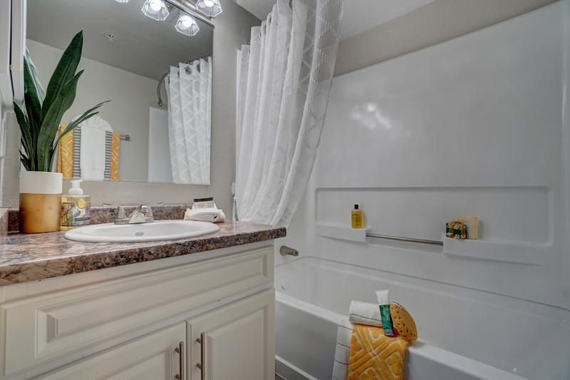 Bathroom | Our bathrooms come with gorgeous granite-style countertops and plenty of storage with cabinetry below and a medicine cabinet too!