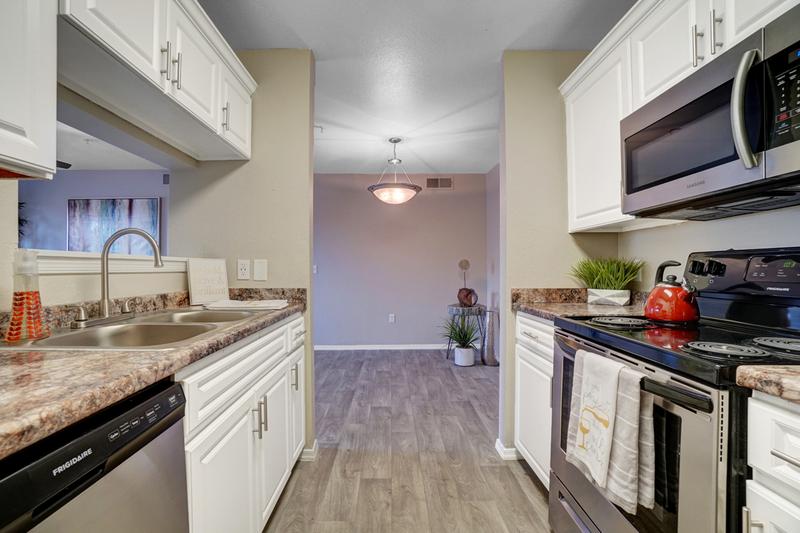 Stainless Steel Appliances | The kitchen offers plenty of cabinet space as well and opens up into the dining and living room; perfect for entertaining!