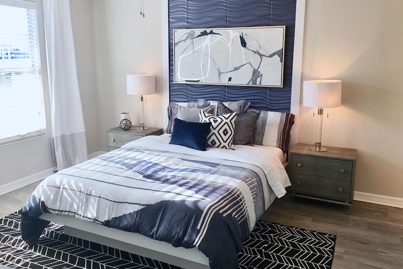 Signature Bedroom | Our Signature bedrooms feature wood-style flooring and multi-speed ceiling fans.