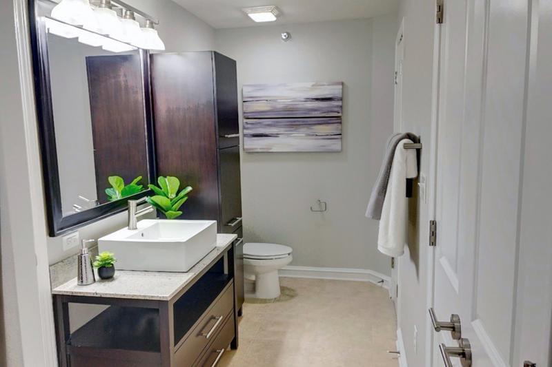 Master Bathroom | Master bathroom featuring granite-style countertops, expansive mirror and an abundance of cabinet space.