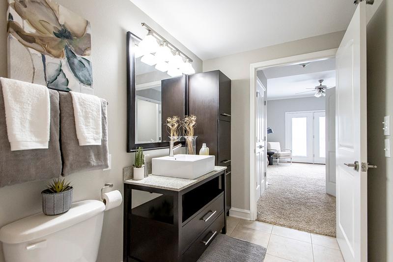Master Bathroom | Master bathroom featuring granite-style countertops, expansive mirror and an abundance of cabinet space for storage.