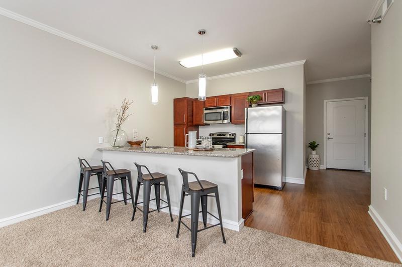 Breakfast Bar | Open kitchens featuring an expansive breakfast bar and updated pendant lighting.