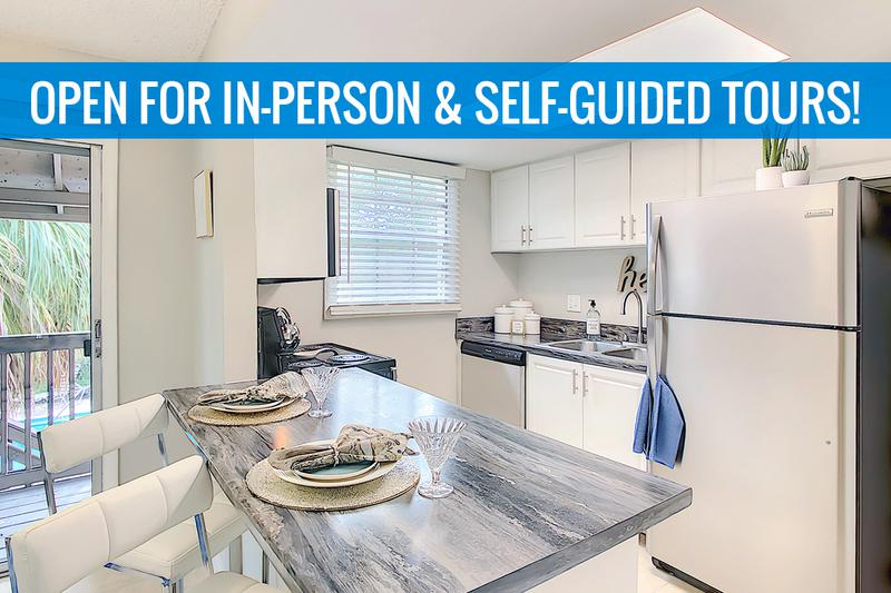Renovated Black Fusion Kitchen | Newly renovated kitchens with updated white cabinetry and black fusion countertops. We are excited to offer in-person tours while following social distancing and we encourage all visitors to wear a face covering.
