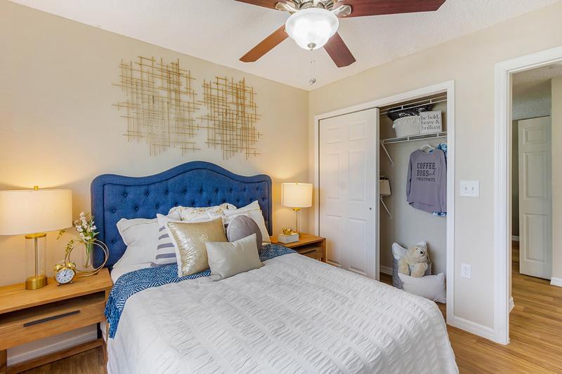 Guest Bedroom | Spacious guest bedrooms featuring large windows and ceiling fans, and a closet with built-in organizers.
