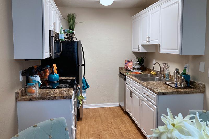 Updated Kitchens | Updated kitchens also feature white cabinetry and wood-style flooring.