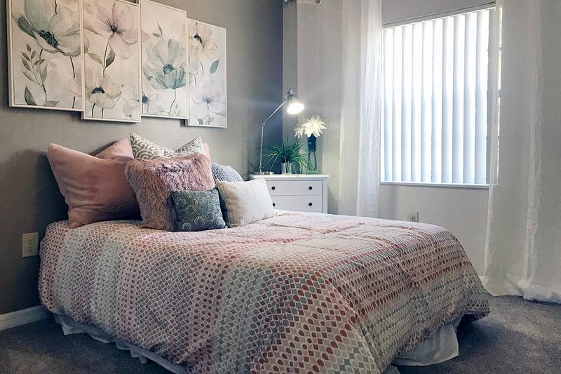 Bedroom | The spacious bedrooms with walk-in closets also feature beautiful views of our lush landscaping and sparkling pond.