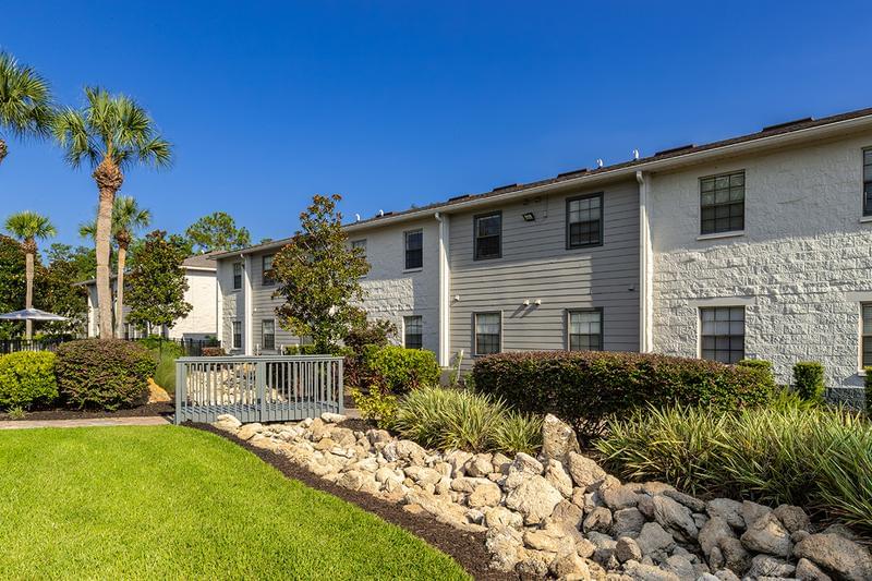 Building Exterior | You'll be welcomed home with lush landscaping and freshly painted buildings.