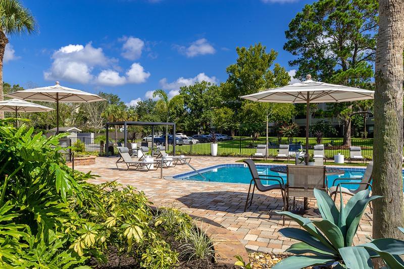 Poolside Seating | Our sundeck features plenty of umbrellaed tables.