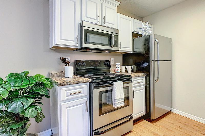 Updated Kitchens | Your newly renovated kitchen in the Deluxe Chateau floor plan features upgraded white cabinetry and modern stainless steel appliances.