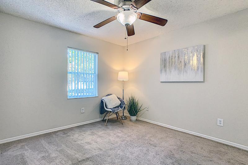 Chateau Bedroom | Spacious bedrooms featuring plush carpeting and multi-speed ceiling fans.