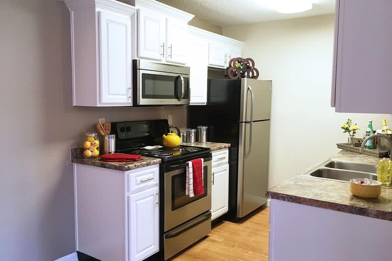 Upgraded Kitchen | Your newly renovated kitchen in the Deluxe Chateau floor plan features upgraded white cabinetry and modern stainless steel appliances. We are excited to offer in-person tours while following social distancing and we encourage all visitors to wear a face covering.