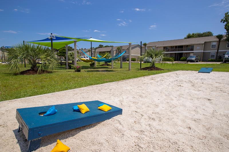 Corn Hole | Play a game of corn hole at our sanded game area located next to the hammock garden.