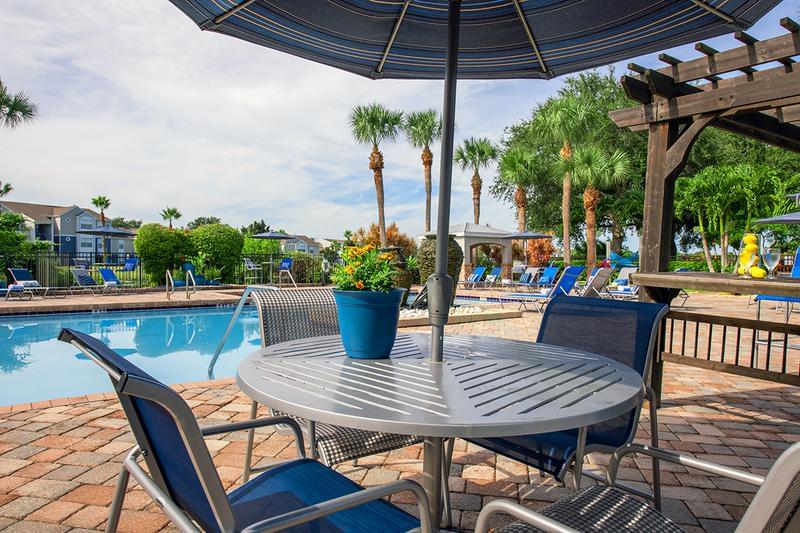 Poolside Tables | Pool deck overlooking Mallard's Landing Golf Course.
