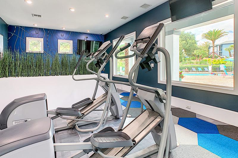 Ellipticals | Enjoy beautiful views of our pool while getting fit on the elliptical.