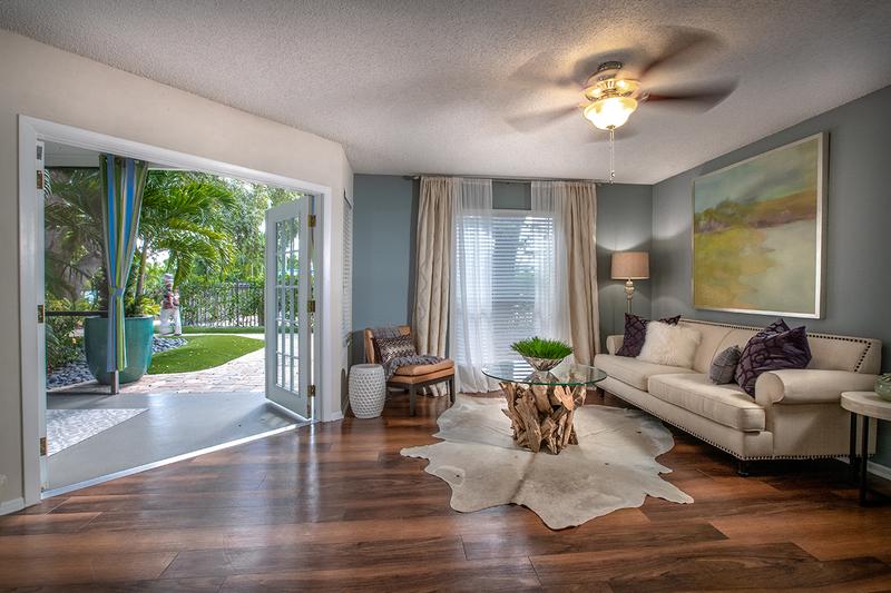 Living Room with Wood-Style Flooring | Your spacious living room has a sliding glass door leading to your very own private lanai.