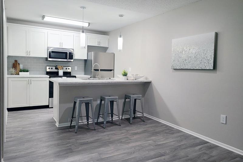 Premium Kitchen | Premium kitchens feature beautiful marble-style countertops, a tile backsplash, and a breakfast bar.