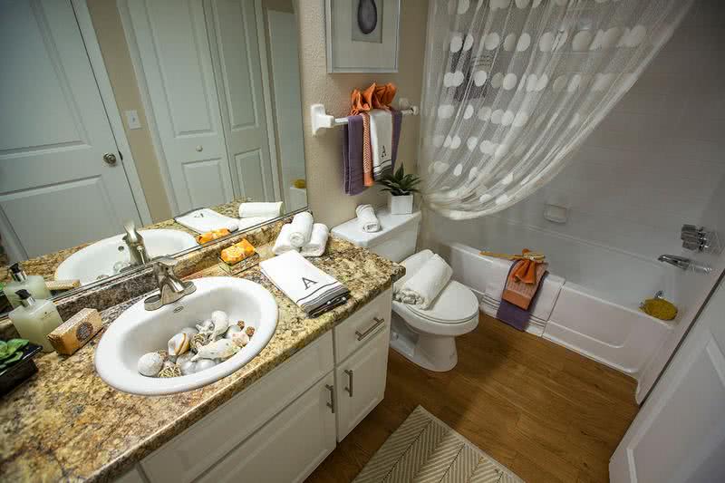 Bathroom | Designer bathroom with new granite style counter tops and modern vanity with exceptional storage space.