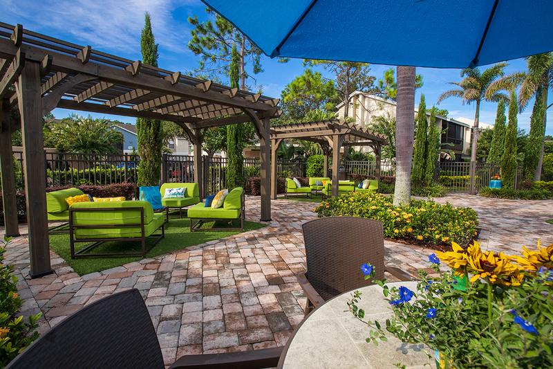 Poolside Tables & Pergolas | Sit at one of our poolside tables with umbrellas or under one of our pergolas.
