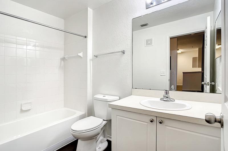 Bathroom | Bathrooms featuring wood-style flooring and large mirrors.