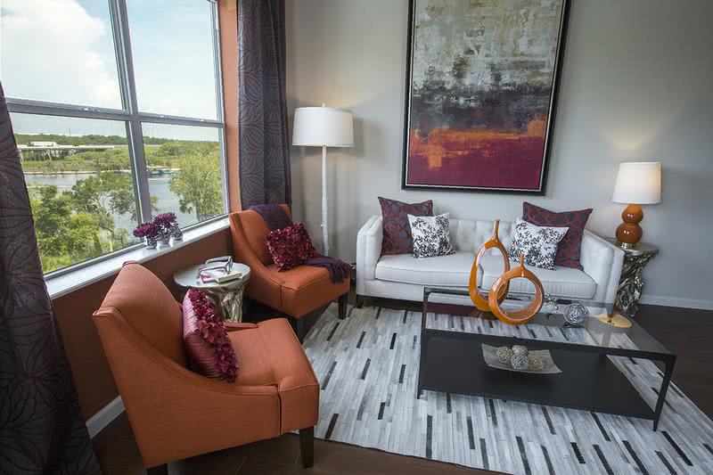 Living Room | Spacious living rooms with wood-style flooring and large windows.