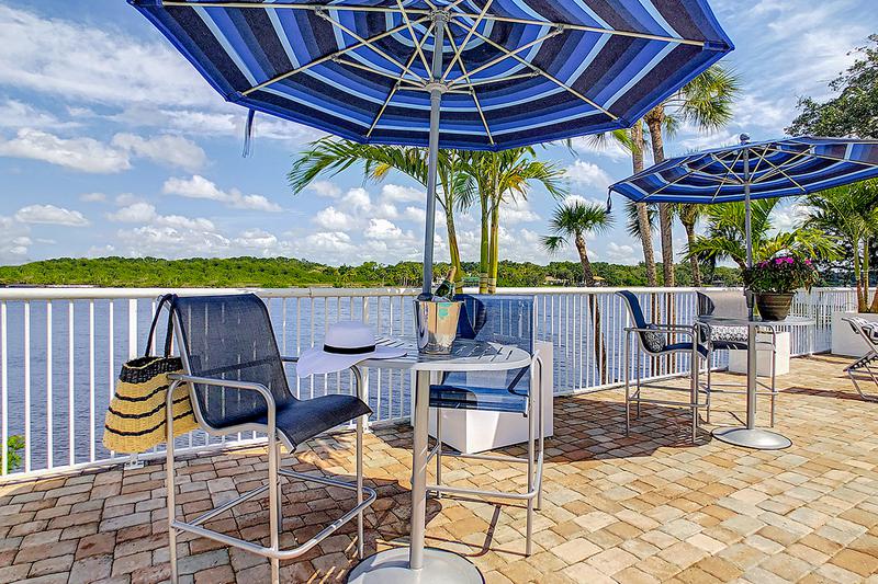 Fantastic Riverfront Views | Have a seat under our shaded tables featuring umbrellas.