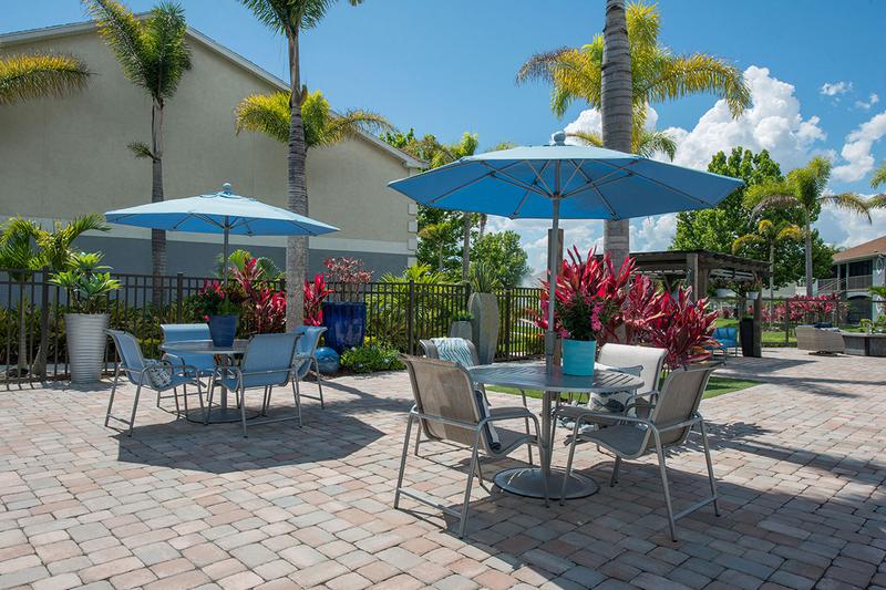 Poolside Tables | Our expansive sundeck features plenty of tables with umbrellas.