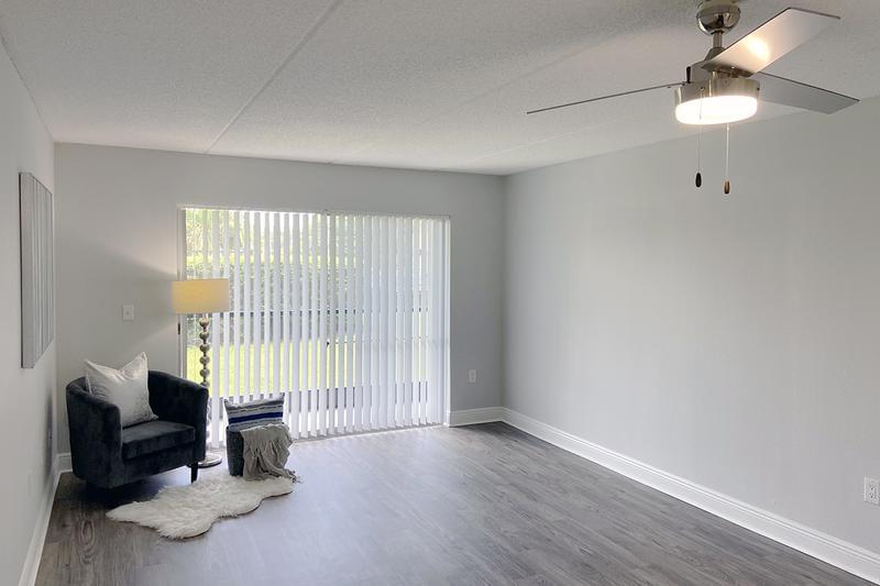 Living Room | Spacious living rooms featuring wood-style flooring.