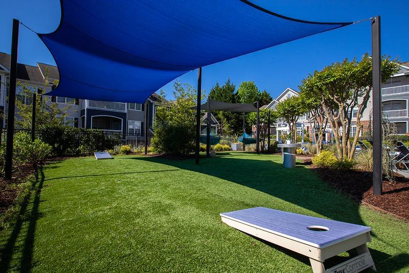 Cornhole | Play a game of cornhole while relaxing by the pool.