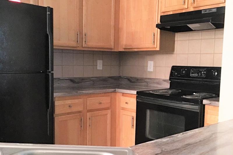 Black Appliances | Our classic style kitchens feature maple cabinetry, black fusion countertops, and black appliances.