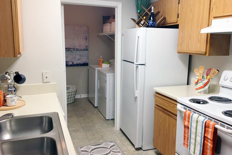 Classic Kitchen | Kitchens featuring a breakfast bar, ample cabinetry, and a laundry room.