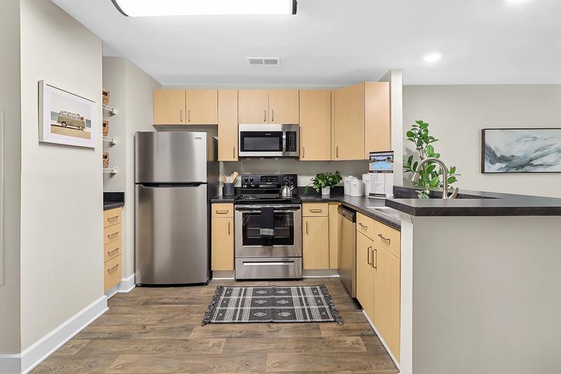 Premier Kitchen | You'll love our renovated kitchens featuring a ample cabinetry, stainless steel appliances, and a breakfast bar.