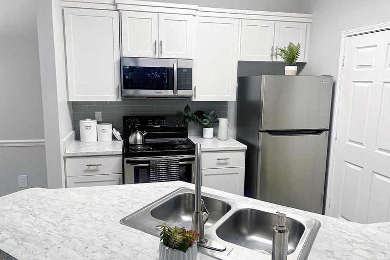 Kitchens with Carrera Countertops | Select apartments feature white Carrera marble countertops & kitchen islands.