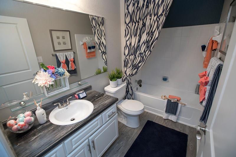 Bathroom | Our spacious yet practical baths offer wood style flooring and large vanity area with medicine cabinet.