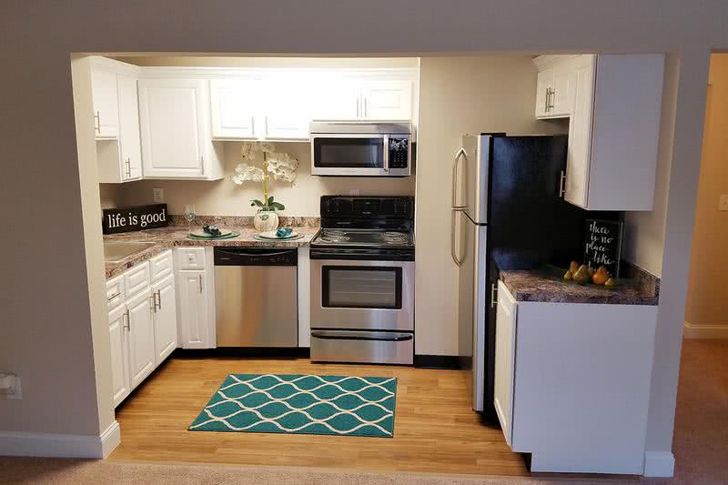 First Floor 1 Bedroom Kitchen | Newly renovated kitchens featuring wood-style flooring, granite-style counters and stainless steel appliances.