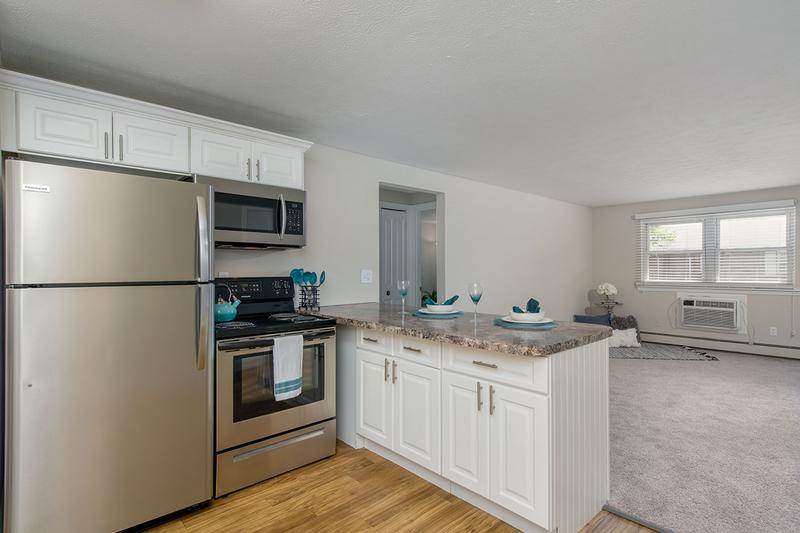 Updated Kitchen | Updated kitchens featuring wood-style flooring and stainless steel appliances.