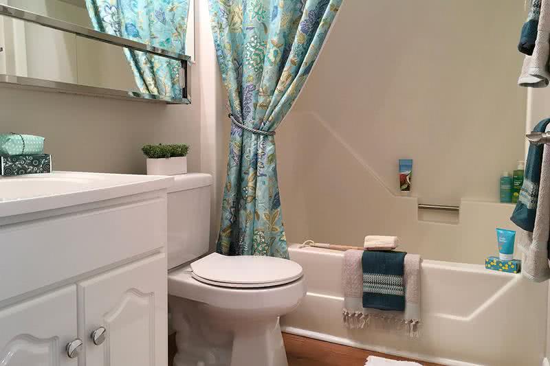 Bathroom | Newly renovated bathrooms featuring large mirrors and wood-style flooring.