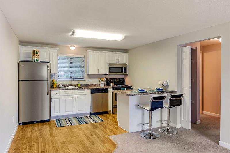 Kitchens with Breakfast Bar | Kitchens featuring wood-style flooring and a breakfast bar overlooking the living room.