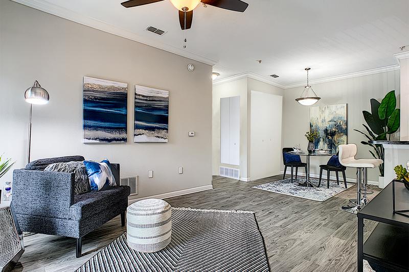 Renovated Living Rooms - In Select Homes | Updated living rooms with wood-style flooring.