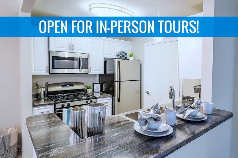 Kitchen | We are excited to offer in-person tours while following social distancing and we encourage all visitors to wear a face covering. Galley style kitchens featuring stainless steel appliances, black fusion counter tops, wood-style flooring, and a breakfast bar.