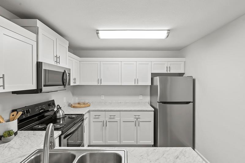Kitchen | Kitchens featuring ample cabinetry and a breakfast bar overlooking the living area.