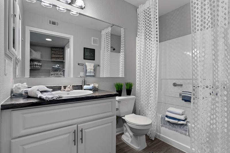 Bathroom | Updated bathrooms with black fusion counter tops and large mirrors available.