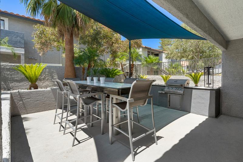 Outdoor BBQ Lounge Area | Enjoy views of the pool while having a cook out at our outdoor kitchen.