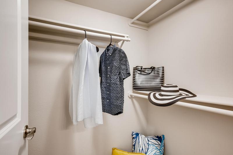 Spacious Walk-In Closets | Walk-in closets featuring built-in organizers.