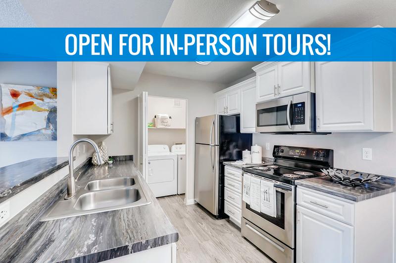Kitchen | Kitchens featuring black fusion counter-tops, white cabinetry, and stainless steel appliances. We are excited to offer in-person tours while following social distancing and we encourage all visitors to wear a face covering.