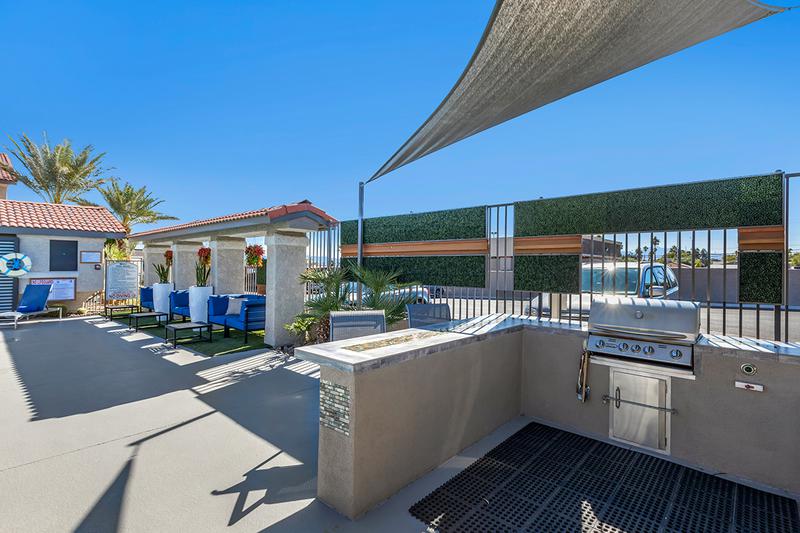 Outdoor Kitchen | Have a cookout poolside at our outdoor kitchen featuring a gas grill.