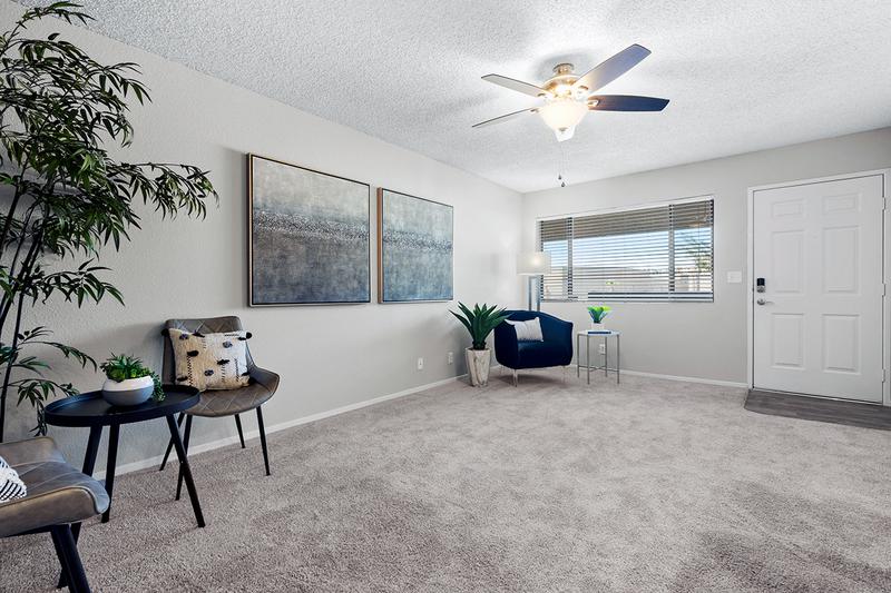 Living Room | Updated living rooms with plush carpeting and a ceiling fan.