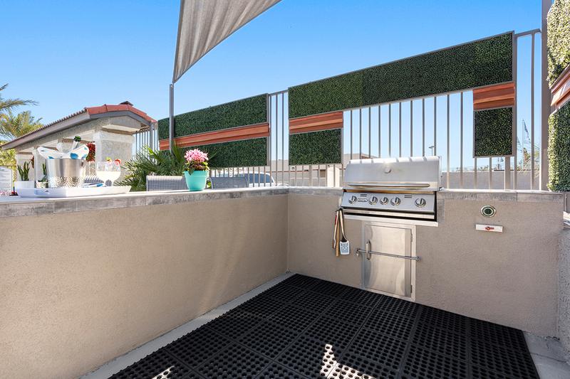 Outdoor Kitchen | Have a cookout poolside at our outdoor kitchen featuring a gas grill.