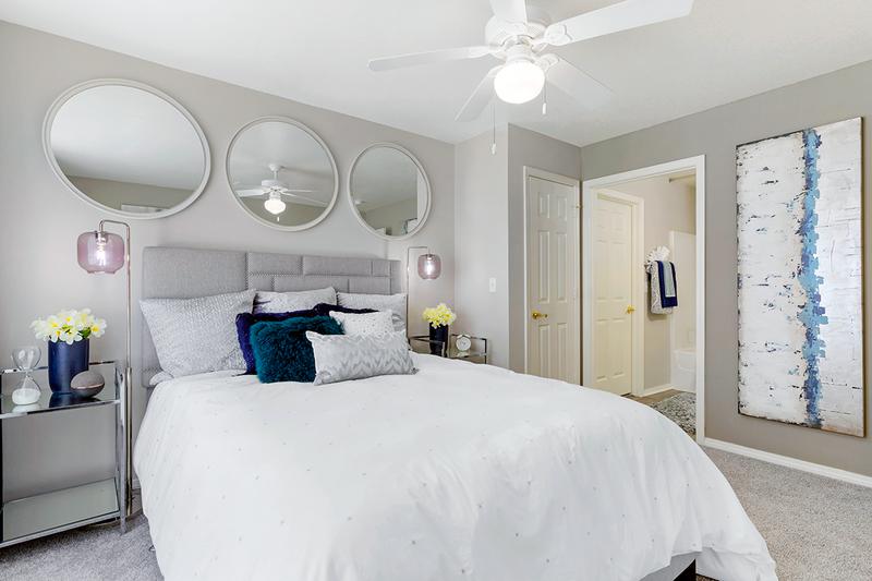 Master Bedroom | Elegant master bedrooms featuring a multi-speed ceiling fan and a walk-in closet.