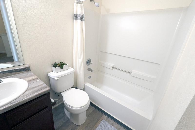 Bathroom | Bathrooms featuring wood style flooring and large vanities.